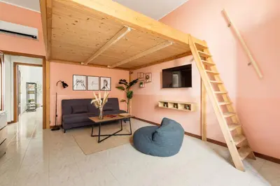 a living room with a ladder and a couch at Imperial Nazionale in Rome