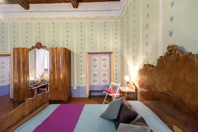 a bedroom with a bed and a mirror at Casa Savelli in Rome