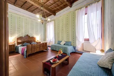 a living room with two beds and a couch at Casa Savelli in Rome