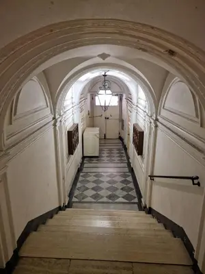a hallway in an old building with a checkered floor at Casina Giubbonari in Rome
