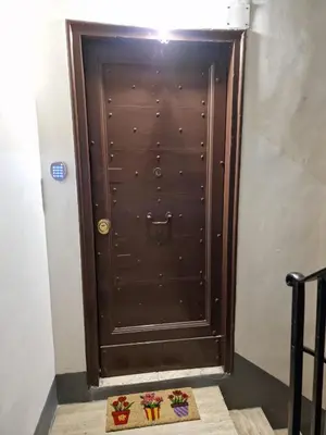 a brown door with some flowers in front of it at Casina Giubbonari in Rome