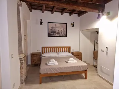 a bedroom with a bed with two towels on it at Casina Giubbonari in Rome
