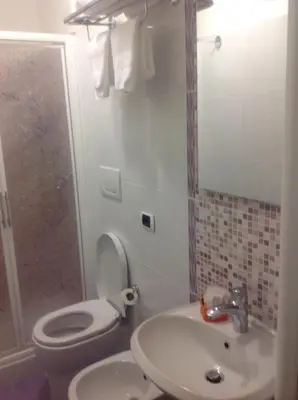 a bathroom with a toilet and a sink and a shower at Guglielmo Marconi House in Rome