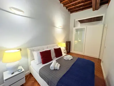 a bedroom with a bed with two towels on it at DOMVS SPAGNA Via Gregoriana in Rome