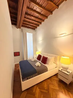 a bedroom with a large bed in a room at DOMVS SPAGNA Via Gregoriana in Rome