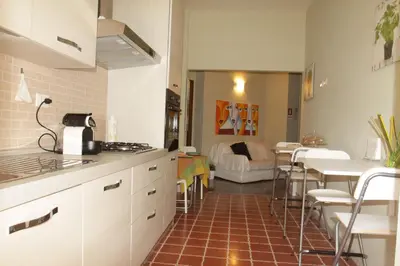 a kitchen and living room with a table and a couch at B&B Di Leo in Rome