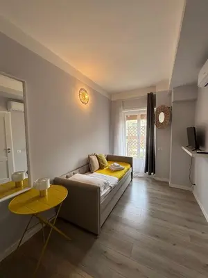 a living room with a couch and a table at Matilda House Trastevere 8 posti letto in Rome