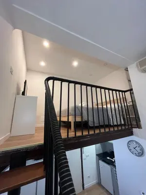 a room with a bed on the top of a stairs at Studio flat ultimo piano in centro in Rome