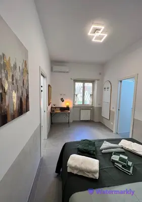 a bedroom with a bed and a desk in a room at ITALIANAS Vatican in Rome