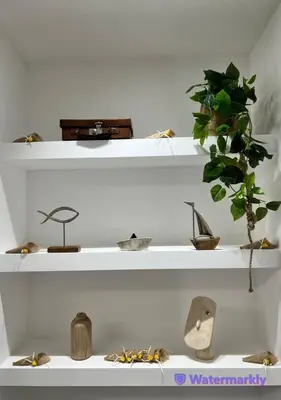 two white shelves with different kinds of items on them at ITALIANAS Vatican in Rome