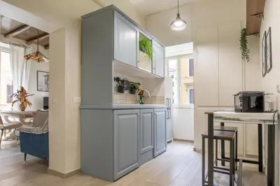 a kitchen with an island in the middle of a room at AD MAIORA SUITE in Rome