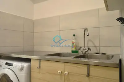 a kitchen with a sink and a washing machine at Retreat in the Heart of Fori Imperiali in Rome