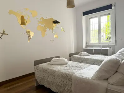 a room with two beds and a world map on the wall at Viale Tirreno - Appartamento con Patio in Rome
