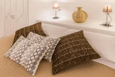 a bed with two pillows and a shelf with lamps at Thebestinrome Orbitelli in Rome