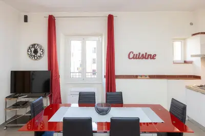 a dining room with a red table and chairs at Principe Amedeo By Rental in Rome in Rome