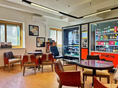 a waiting room with chairs and tables in a store at L' oasi di Roma - Modern apartment with pool&parking in Rome
