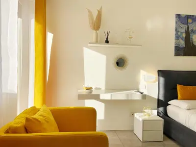a living room with a yellow couch and a sink at L' oasi di Roma - Modern apartment with pool&parking in Rome