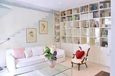 a living room with a white couch and a chair at Incanto Italiano in Rome
