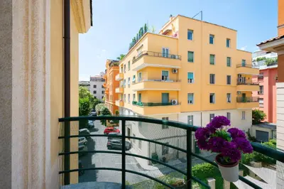 a balcony with a flower pot and some buildings at La Divina Duse in Rome