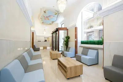 a waiting room with blue chairs and a table at Hotel Maximus in Rome