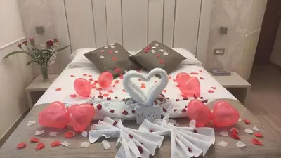 a bed with a bunch of hearts on it at Hotel Maximus in Rome