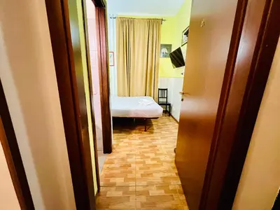a hallway with a room with a bed in it at Booking Inn Settembre 95 in Rome