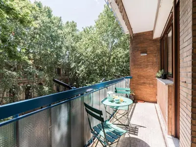 a balcony with a table and chairs on it at The Best Rent - Apartment in Trastevere area in Rome