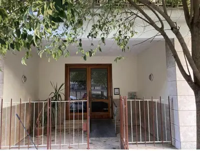 an entrance to a house with a gate and a tree at Vintage House in Rome