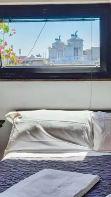 a bedroom with a window with a white bed and a pillow at BrandNew House on the Terrace in Rome