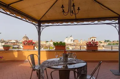 a table and chairs on a patio with a view at BrandNew House on the Terrace in Rome