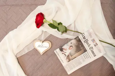 a wedding dress with a newspaper and a red rose at La Suite di San Pietro in Rome