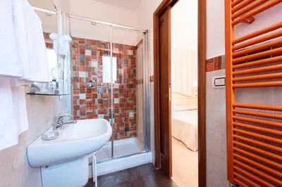 a bathroom with a sink and a shower at La Suite di San Pietro in Rome