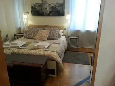 a small bedroom with a bed and a window at LILIUM HOUSE Apts in Rome