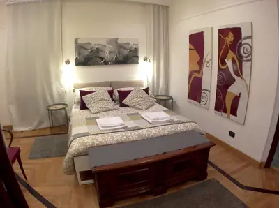 a bedroom with a large bed with red pillows at LILIUM HOUSE Apts in Rome