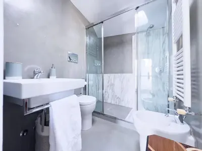 a bathroom with a sink and a toilet and a shower at Casa Triunfo Boutique Apartment in Rome