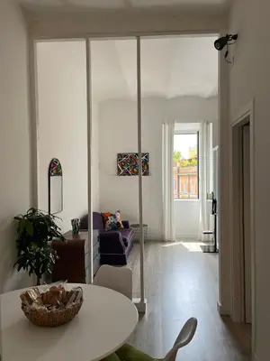 a living room with a table and a couch at Colosseo Living Suites in Rome