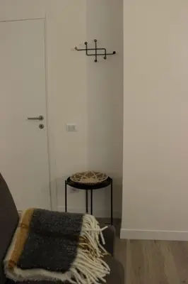 a room with a door and a stool with a blanket at Colosseo Living Suites in Rome