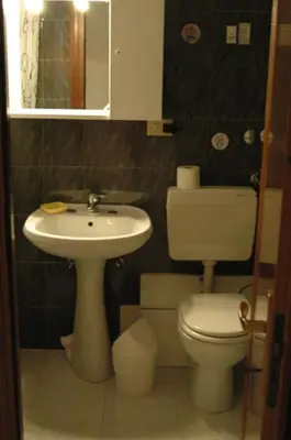a bathroom with a toilet and a sink at Le Rose di Bi in Rome