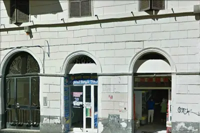 a white brick building with three arched windows at Le Rose di Bi in Rome