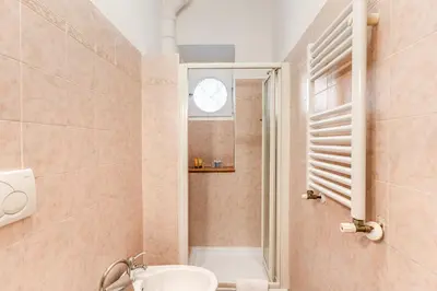 a bathroom with a sink and a shower with a window at Lovely flat in Testaccio in Rome
