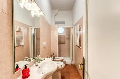 a bathroom with two sinks and two toilets at Lovely flat in Testaccio in Rome