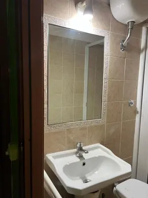a bathroom with a sink and a mirror and a toilet at Magenta Roma house in Rome