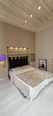 a bedroom with a large bed in a room at Savelli Apartment Old Town - near Navona Place in Rome