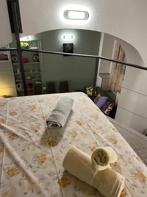 a bedroom with a bed with a towel on it at la rosa di roma colosseo in Rome