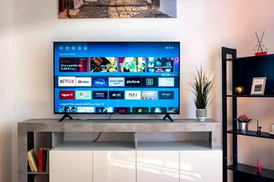 a television on a tv stand in a living room at Green Window Roma in Rome
