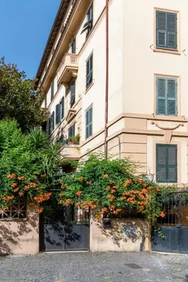 a building with orange flowers in front of it at Green Window Roma in Rome