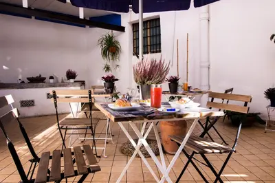 a table with chairs and food on top of it at Casa Maplink in Rome