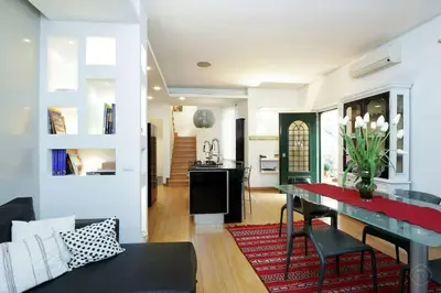a dining room and living room with a table and chairs at Karol Apartment Rome in Rome
