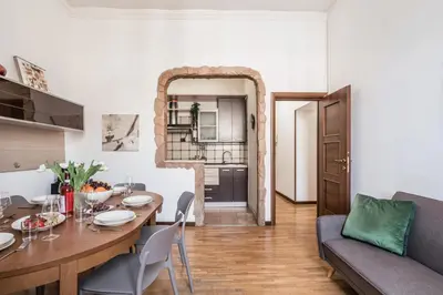 a living room with a table and a couch at The Best Rent - Three-bedroom apartment in Porta Maggiore area in Rome