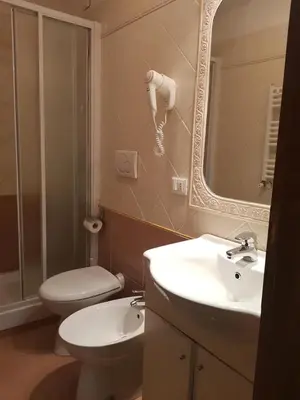 a bathroom with a toilet and a sink and a mirror at B&B Rudy Center in Rome